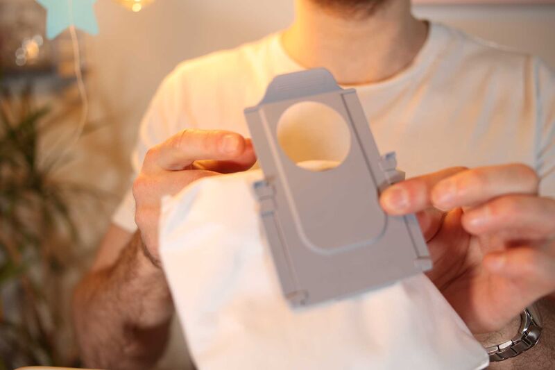 Closing the disposable dust bag.